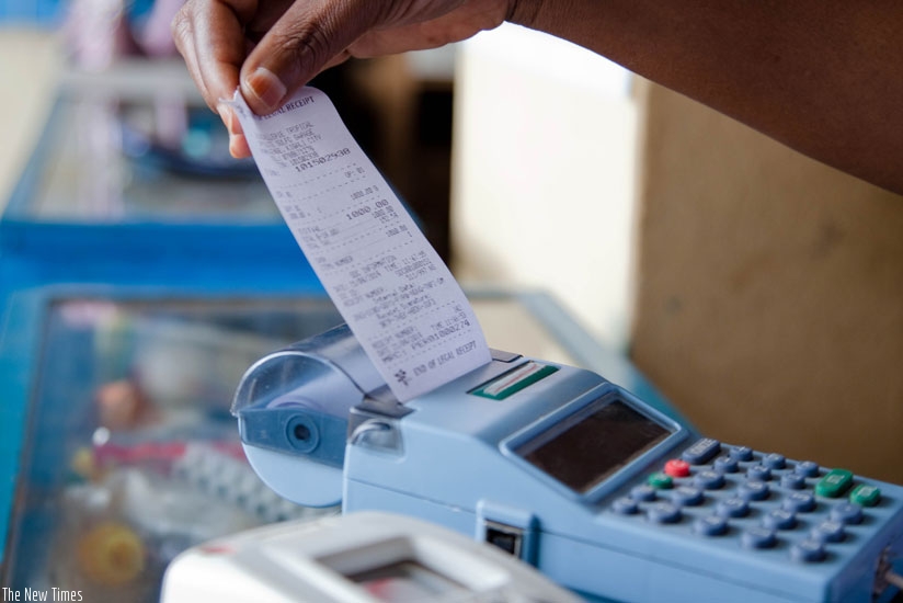 A trader pulls a receipt out of an electronic billing machine. (File)