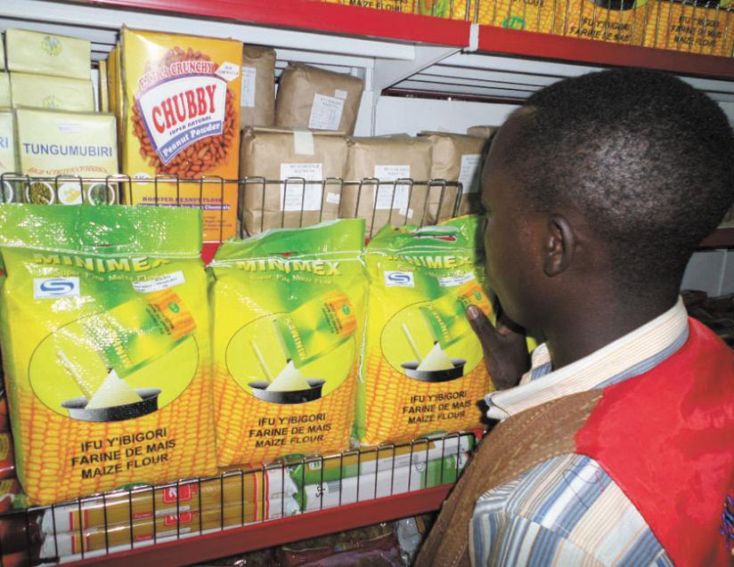 A shopper checks out Minimex maize flour, which is produced in Rwanda. EAC producers want governments to promote their goods. (File)