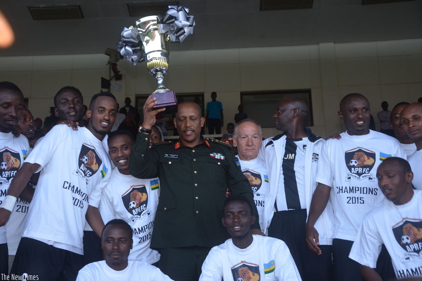 Gen, Patrick Nyamvumba, Chief of Defence Staff of the Rwandan Defence Forces (C) holds the trophy after APR were crowned league champions last season. (S. Ngendahimana)