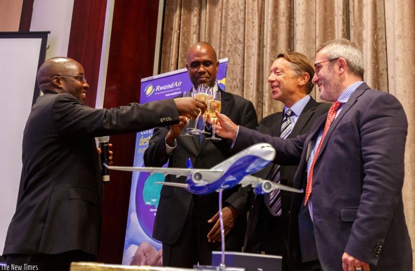 (L-R) Dr Alexis Nzahabwanimana, the State Minister for Transport; John Mirenge, the chief executive officer of RwandAir; Christopher Buckley, the Airbus's executive vice-president Africa, Europe and Asia Pacific; and Kevin Evans, the Rolls Royce vice-president - customers, toast to the deal at the signing ceremony in Kigali yesterday. (Timothy Kisambira)