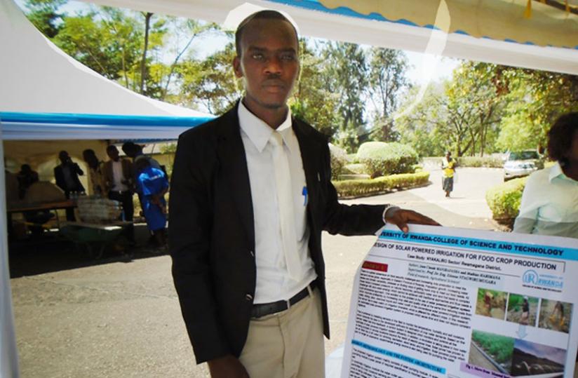 Manirafasha poses with a dummy of the project study he carried on solar-powered irrigation technology for his research at University of Rwanda. (Michel Nkurunziza)