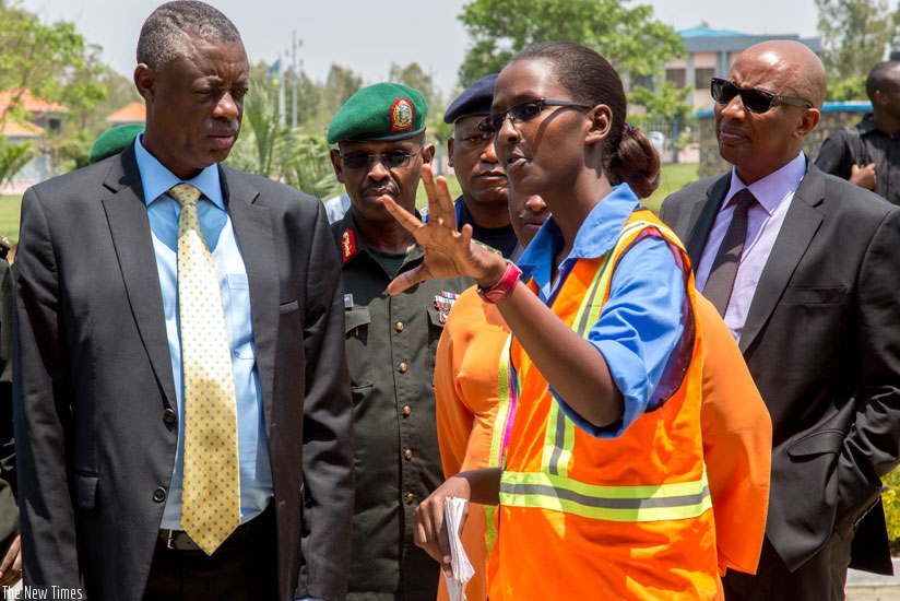 Eng. Linda Ingabire (R) explains to Minister Kabarebe and other officials the number of students that will occupy the newly constructed dormitories and dining hall at Gako. (All photos by Doreen Umutesi)