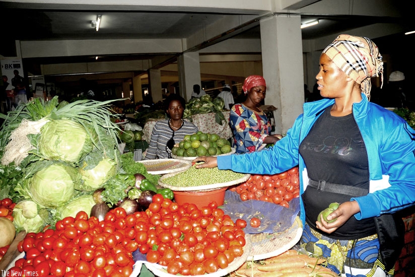 A woman sells vegetables at the City Market. Rwanda has been lauded for pro-women legislation. (File)