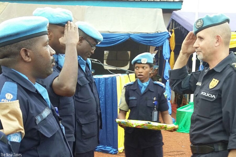 MINUSCA Police commissioner Luis Miguel Carrilho (R) salutes Rwandan Police officers at the medal awards ceremony in Bangui, CAR.  (Courtesy)