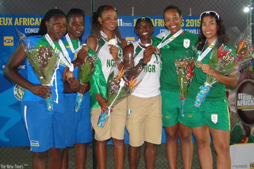 Rwanda's Denyse Mutatsimpundu and Charlotte Nzayisenga (L) pose on the podium alongside Nigerian gold medalists (C) and the silver medal winners from South Africa. (Courtesy)