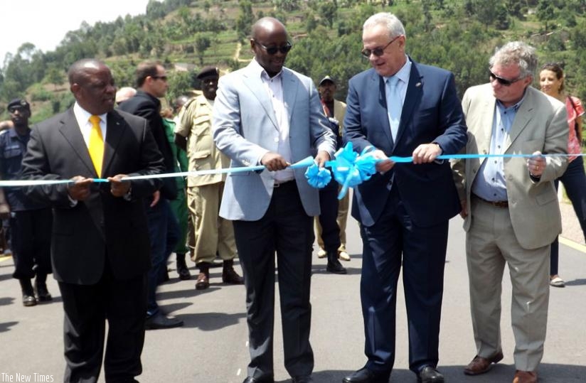 Infrastructure minister James Musoni (2nd L) and Neven Mimica, the European Union commissioner for cooperation (2ndR) cut the ribbon to inaugurate the Kigali-Gatuna road in Gicumbi yesterday. Looking on is Northern Province governor Aime Bosenibamwe (L) and Michael Ryan, the Head of EU Delegation in Rwanda. (Elysee Mpirwa)
