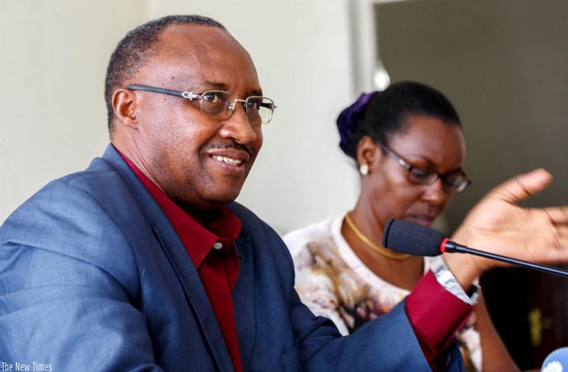 Protais Musoni, the chairperson of the Rwanda Chapter of the Pan-African Movement (L), speaks during the meeting with heads of political parties as his deputy, Henriette Umulisa, looks on.(Timothy Kisambira)