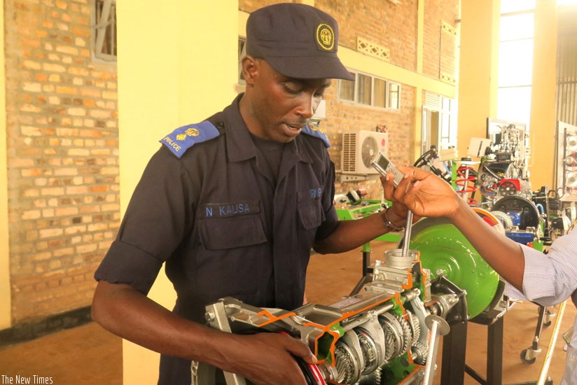 Eng. Senior Superintendant Kalisa explains how the training equipment operate. (All photos by S. Rwembeho)