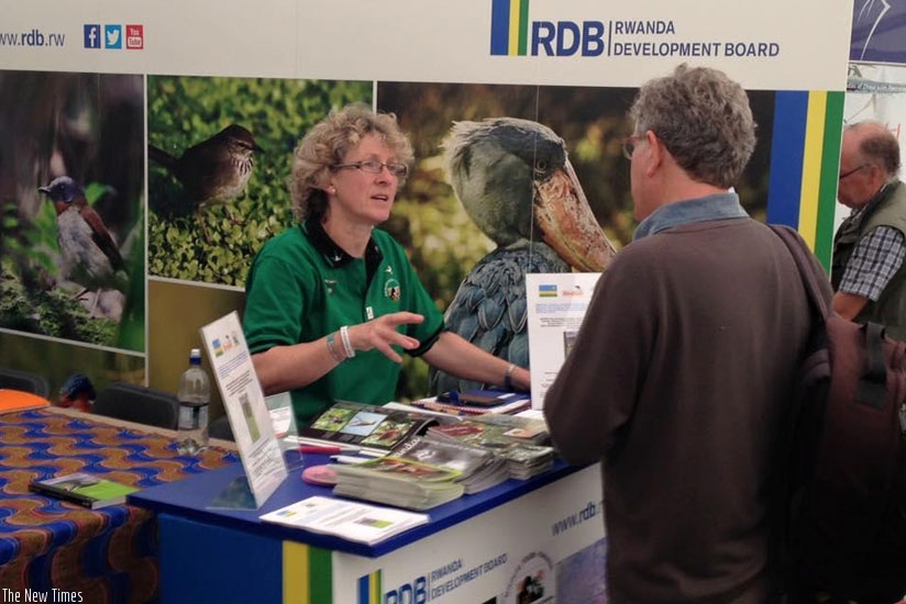 A volunteer from the Royal Society for the Protection of Birds explains a point to a visitor to the Rwandan stand. (Courtesy)