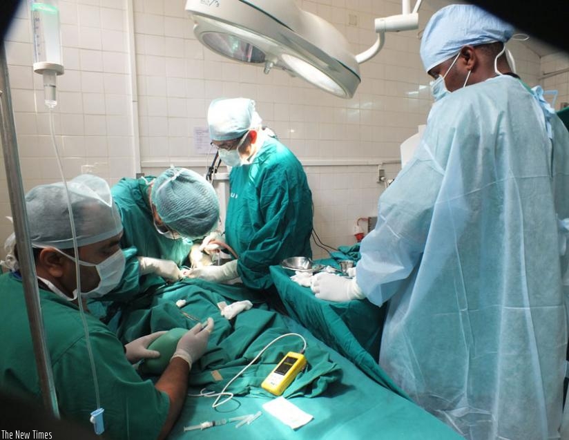 A cleft lip and palate patient undergoing surgery at Rwamagana Hospital last month. Inset is a photo of a child born with cleft lip and palate.  (Lydia Atieno)