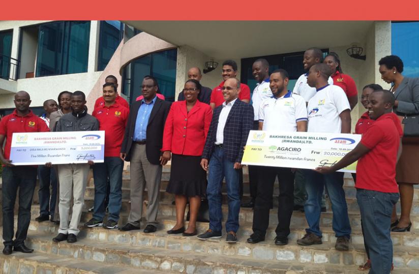 Ministers Gatete (second left) and Mukeshimana pose for a group photo with Azam officials after receiving the donation.  (Peterson Tumwebaze)