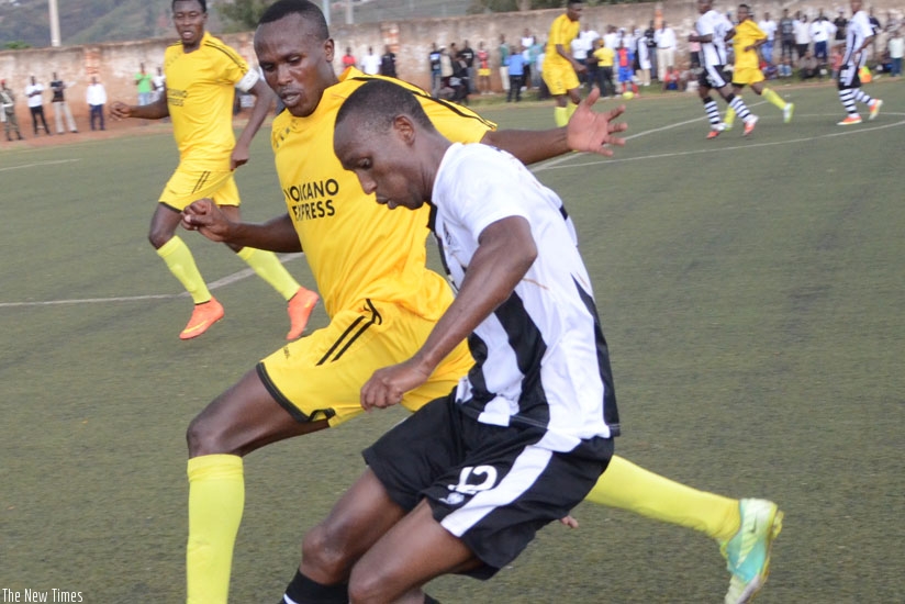 APR midfielder Jean Claude Iranzi tries to go past a Mukura player during last season's league match at Muhanga stadium. (Sam Ngendahimana)