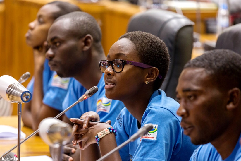 Assia Umuranga (C) from Groupe Scolaire Gatagara in Huye District speaks at Parliament as Monicah Kayezu (L), Jean Claude Urengejeho (2ndL)  and  Jean Claude Makuza (R) look on.  (All photos by Timothy Kisambira)