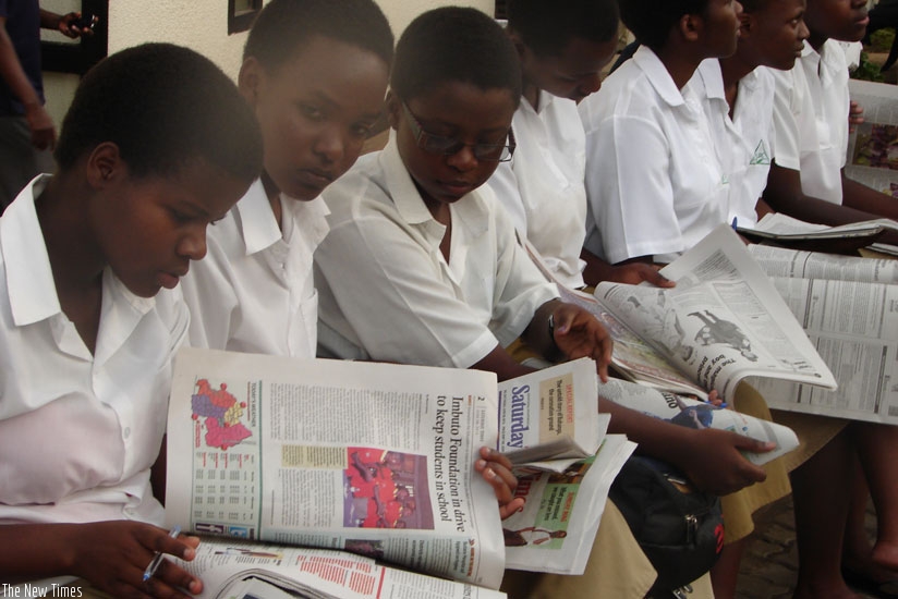 Students read newspapers at The New Times head office. (Timothy Kisambira)