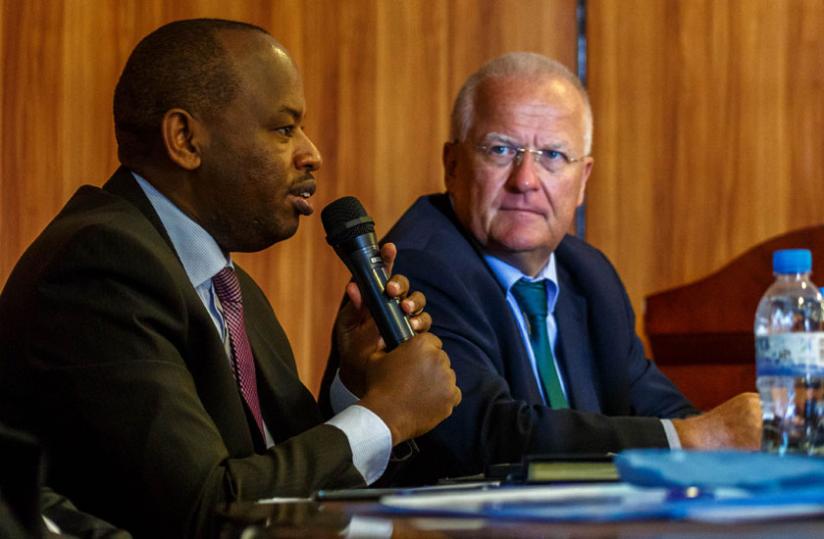 Minister Nsengiyumva ( L) speaks at the workshop in Kigali, yesterday, as Amb. Fahrenhltz looks on. (Timothy Kisambira)