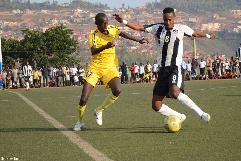 Mukura's Abou Ndayigamiye (L) vies for the ball with Yannick Mukunzi of APR at the Mumena Stadium yesterday. (Sam Ngendahimana)