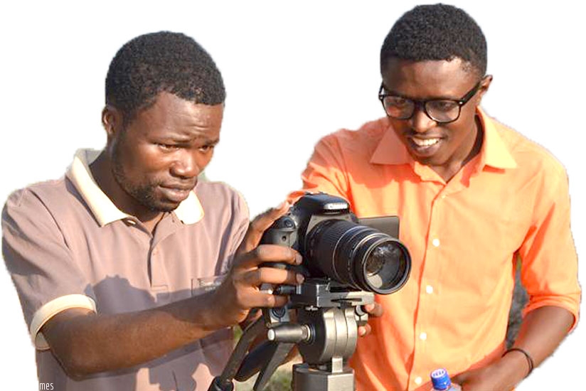 Yves Amuli (R) shows an unidentified man how to use a camera. (Courtesy photo)