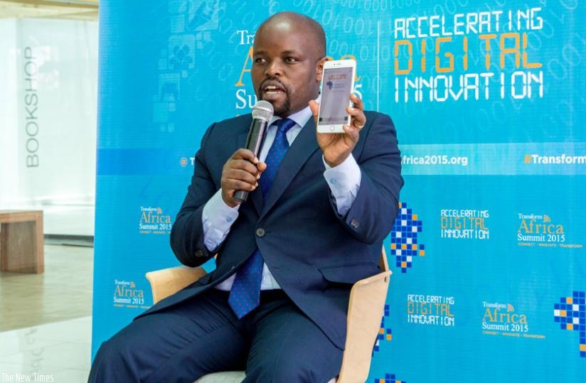 Youth and ICT minister Jean Philbert Nsengimana shows the Transform Africa web site using the QR Scan Code in Kigali yesterday. (Doreen Umutesi)