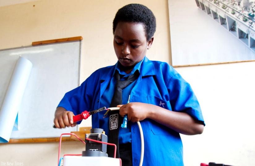 Charlene Byukusenge, a vocational student from Groupe Scolaire ADB Nyarutarama High School in Gasabo District, fixes her project of design and implementation of sound signaling system at SOS Hermann Gmeiner Technical High School in Kagugu, Gasabo. (Timothy Kisambira)