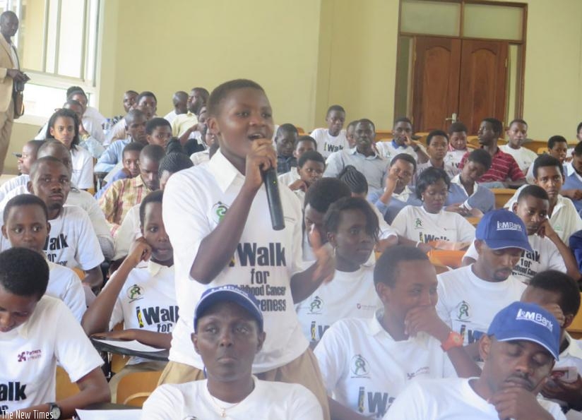 A student asks a question about childhood cancer during the meeting in Kigali on Saturday. (Michel Nkurunziza)