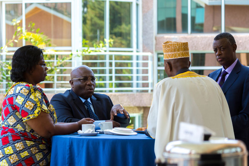 (L-R) DR Congo's defence minister Aime Lusa-Diese Ngoi-Mukena (second left) chats with his hosts, Defence minister James Kabarebe (R), Minister for Disaster Preparedness and Refugee Affairs Seraphine Mukantabana (L), and Internal security minister Sheikh Musa Fazil Harerimana (with back to camera) at Lemigo Hotel in Kigali today. (Timothy Kisambira)