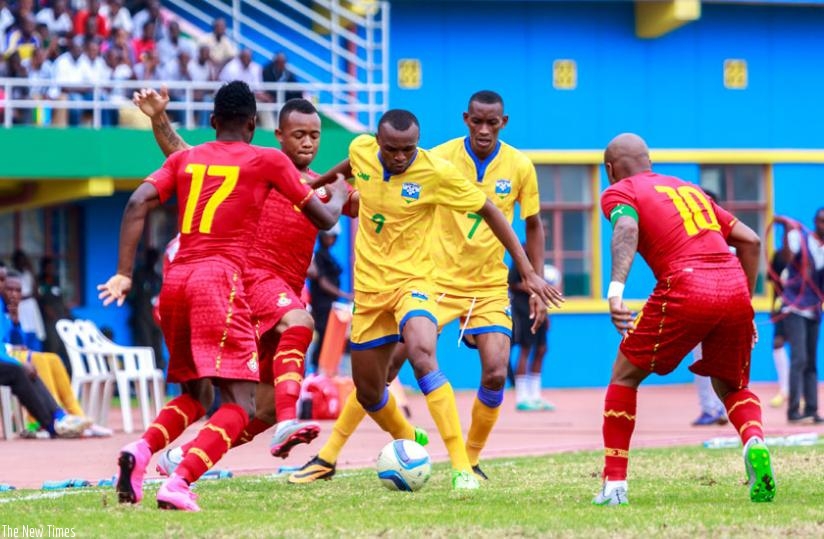 Rwanda's Jacques Tuyisenge (number 9) takes control of the ball against Ghana's Baba Rahman (L) and Dede Ayew (R) earlier this month in AFCON 2017 qualifier. (Timothy Kisambira)