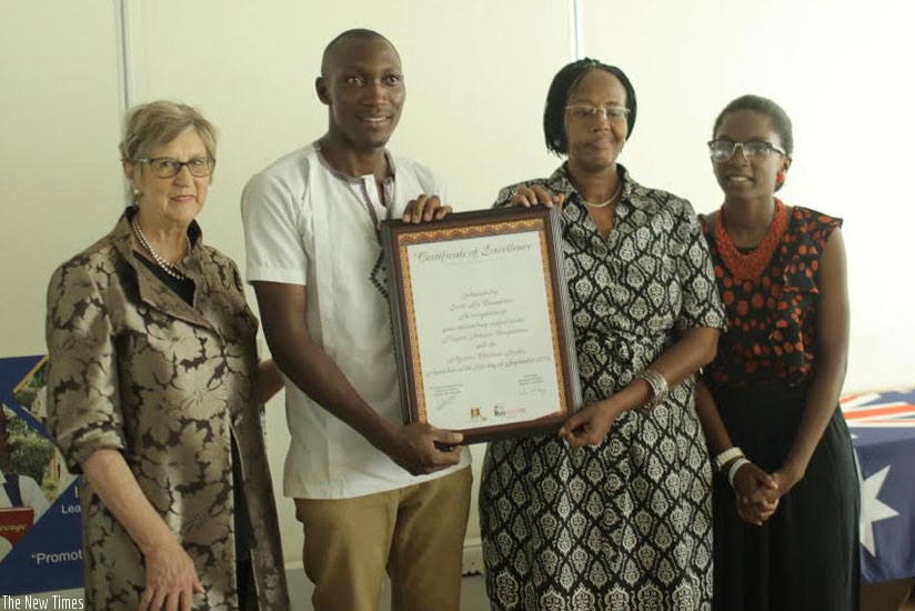 Ecole La columbiere representatives (middle) display the certificate of excellence after winning the competition. With them is Di Fleming (left) and Uwase (right). (Courtesy)