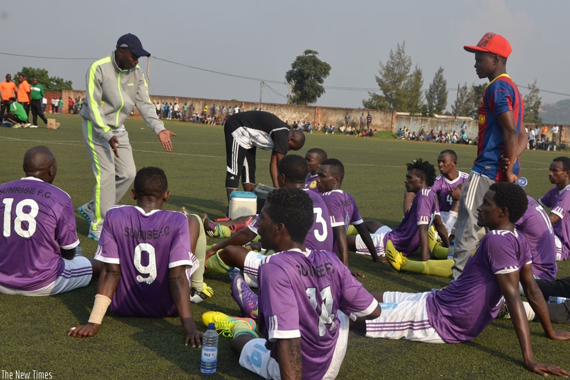 Thierry Nzungu, standing left, seen here with Sunrise players during last season's league game against Kiyovu, is set to be re-appointed as the team's head coach. (S. Ngendahimana)
