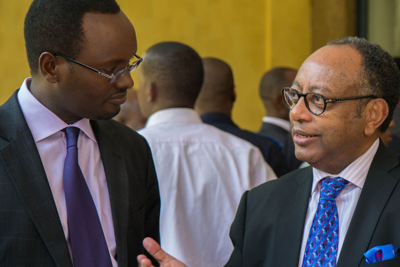 Hategeka (L) chats with WIPO's Shenkoru during a health break in Kigali on Monday. (Timothy Kisambira)