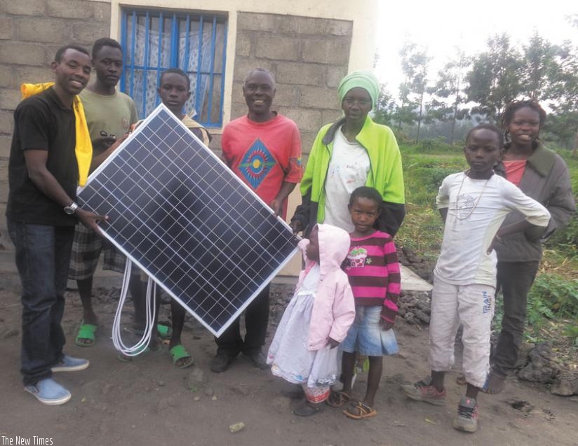 One of the beneficiary families pose for a photo with their solar panel. (Courtesy)