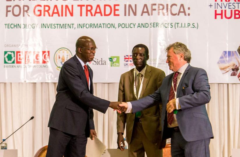 Prime Minister Anastase Murekezi greets Micheal Ryan (L) as Bernard Otim (C) the Chairperson of the Eastern African Grain Council looks on yesterday at Serena Hotel. (Doreen Umutesi)