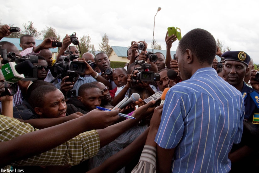 Journalists interview a suspect paraded at the Police headquarters in Kacyiru.   (File)
