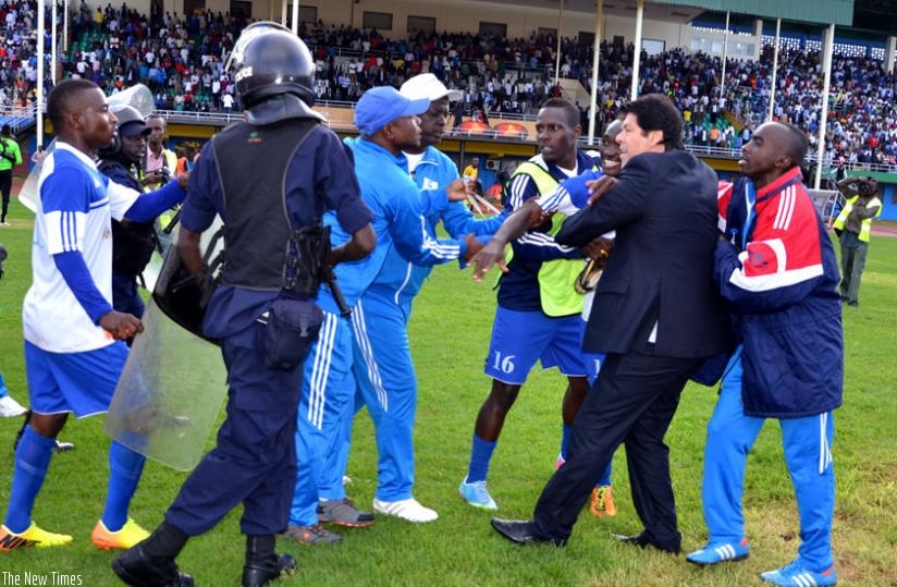 Luc Eymael (in black suit), being pulled away by Rayon Sports team manager Thierry Hitimana during that ill-fated league match against AS Kigali last year. (File)