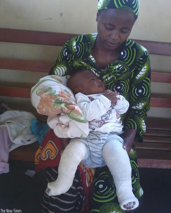 Nirere holds her child after being treated for clubfoot. (Lydia Atieno)