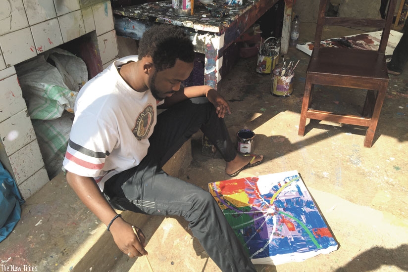Timothy Akimanzi, a Kigali-based visual artist, works on a painting at Inema Art Studio in Kacyiru. Art pieces have huge market abroad. (Moses Opobo)