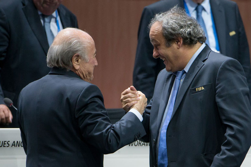 UEFA President Michel Platini (R) congratulates FIFA President Sepp Blatter after he was re-elected at the 65th FIFA Congress in Zurich. (Internet photo)