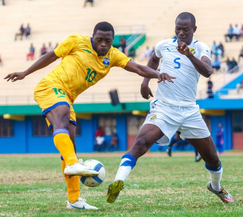 Amavubi forward Isaie Songa (L) attempts a shot against Gabon in a recent friendly match. Songa is among the players that McKinstry will be assessing in Morocco. (Timothy Kisambira)
