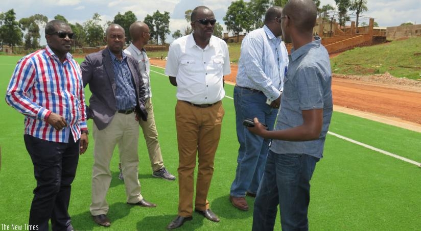 Emmanuel Bugingo (L) and other officials tour the Kamena training ground in Huye District on Thursday. (E. Ntirenganya)
