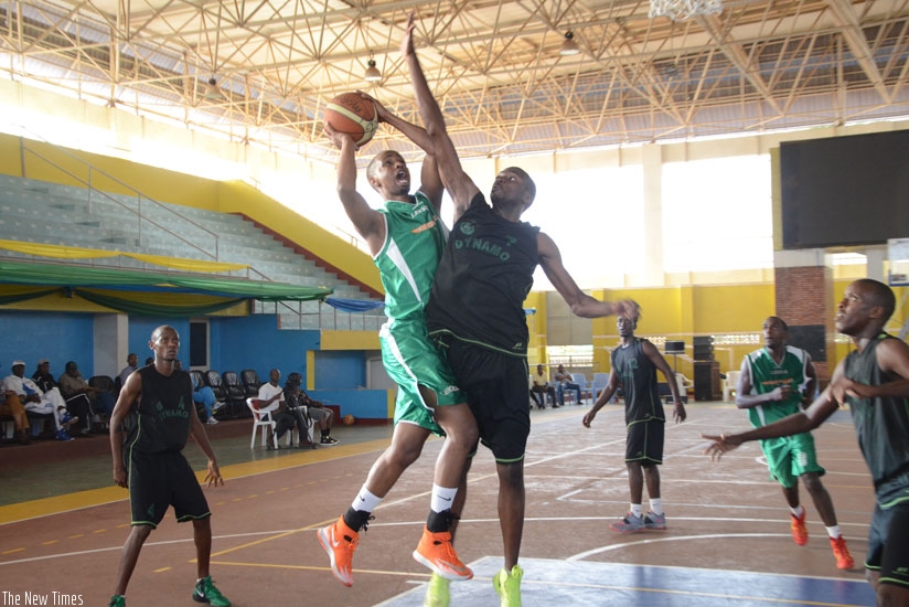 Lionel Hakizimana, left, of Espoir goes for a lay-up against Burundi's Dynamo in the group stage. rn(Sam Ngendahimana)