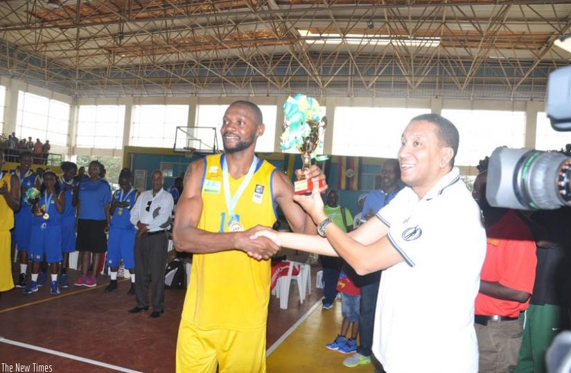 Team Rwanda captain Kami Kabange receives the trophy after the 21-17 win over Egypt in the final. (R. Bishumba)