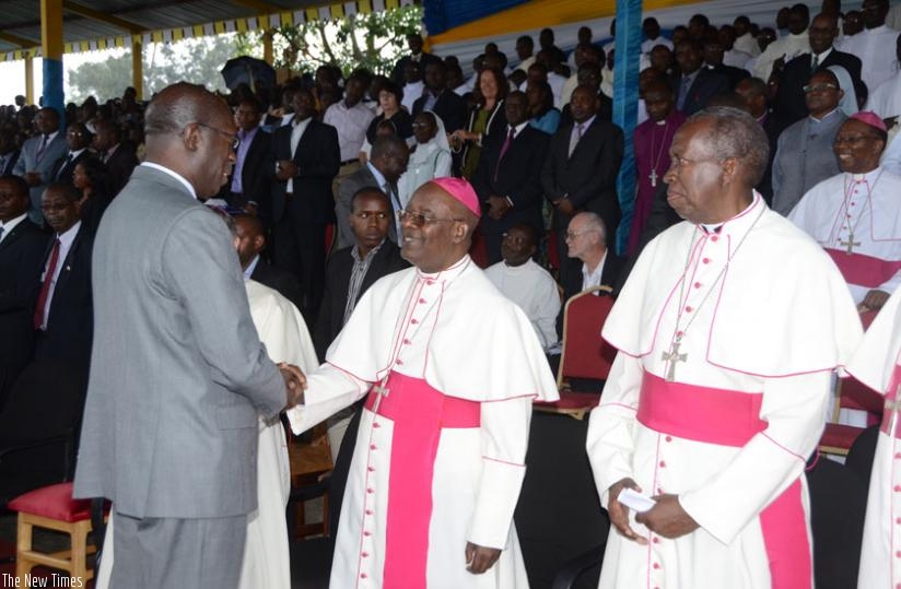 Premier Murekezi greets Bishop Harolimana at the golden jubillee. (Jean Ndungutse)