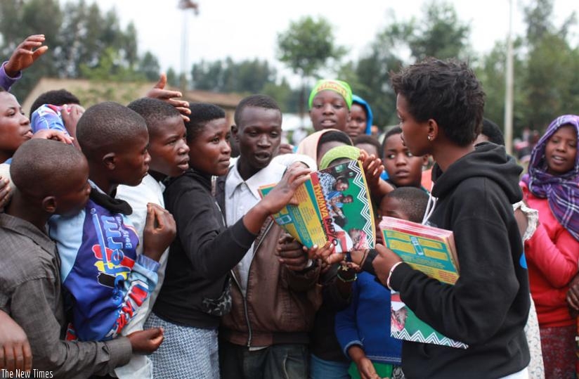 Staff of Ni Nyampinga distribute copies of their magazine to the youth in Nyabihu during the Girl Child Day celebrations in Nyabihu. (Jack Yakubu Nkinzingabo)