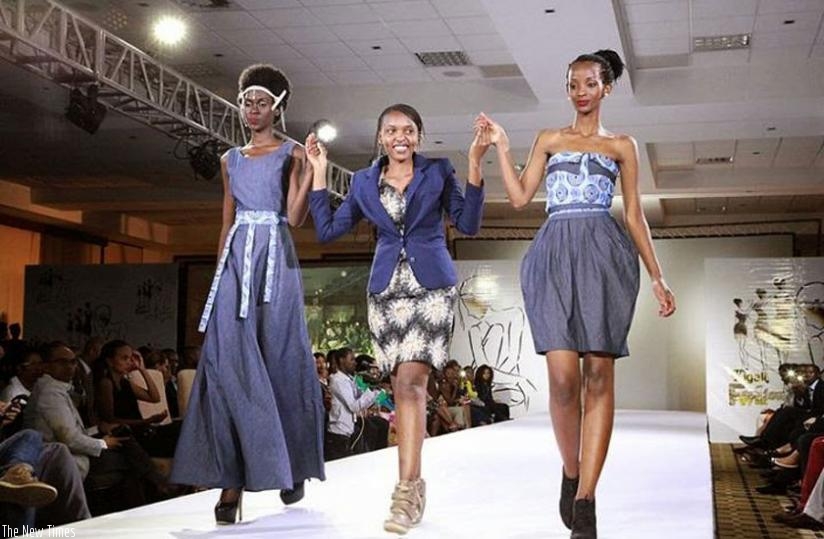 Colombe Ituze Ndutiye, Centre, walks with models clad in her pieces at the Kigali Fashion Week in November, 2013. All photos/ courtesy.
