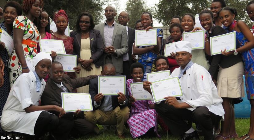 Trainees together with TVET officials pose for a group photo with their certificates at IPRC-South in Huye District on Wednesday. (Emmanuel Ntirenganya)