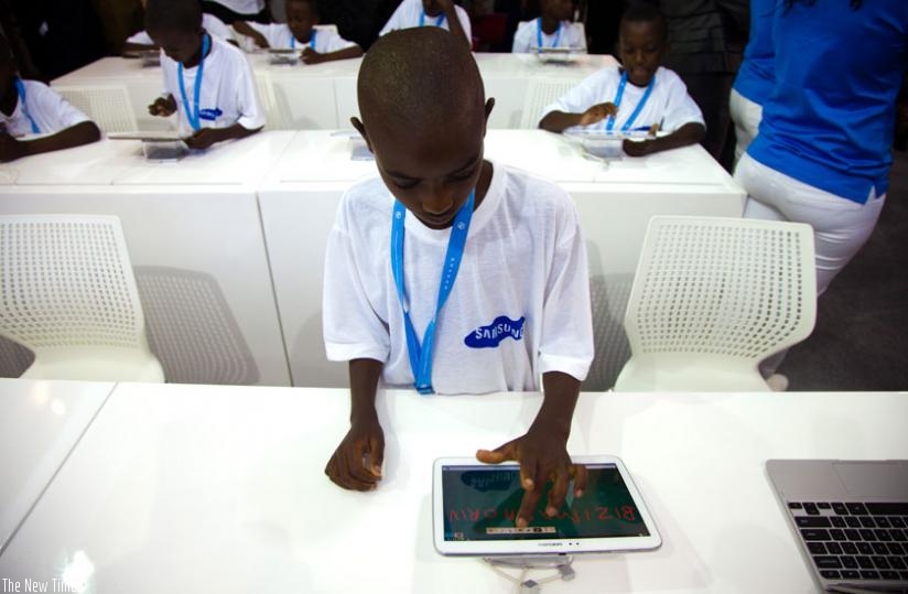 A kid uses a tablet during the 2013 Transform Africa Summit in Kigali. (File)