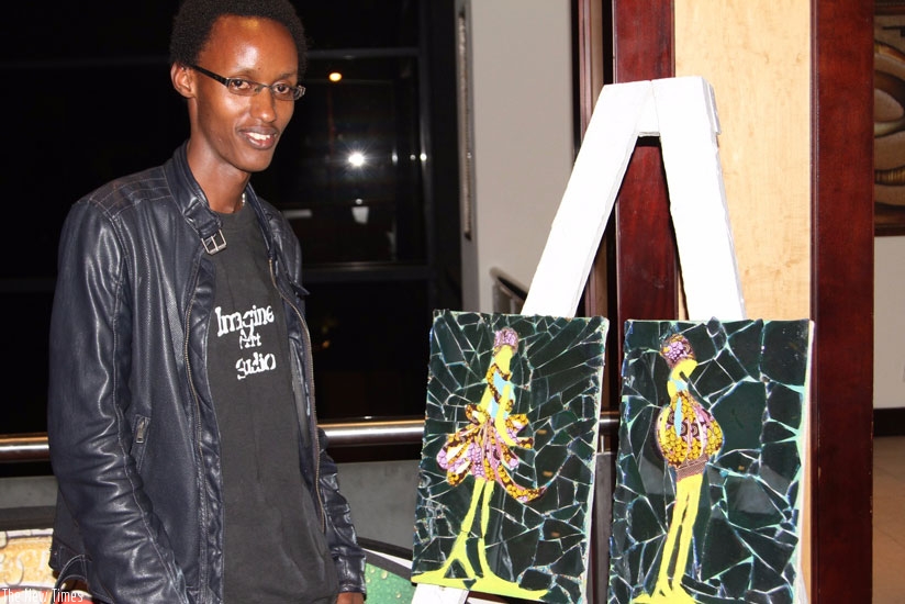 Kayiranga stands next to some of his art pieces. (Julius Bizimungu)