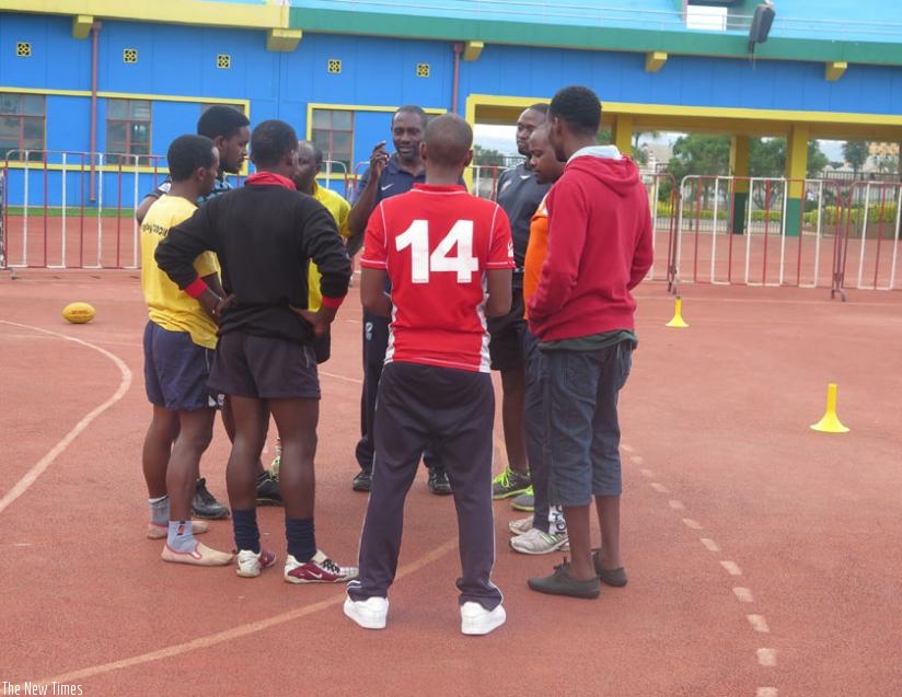 Eric Situma (facing camera) explains a point to the coaches at Amahoro stadium. (S. Kalimba)