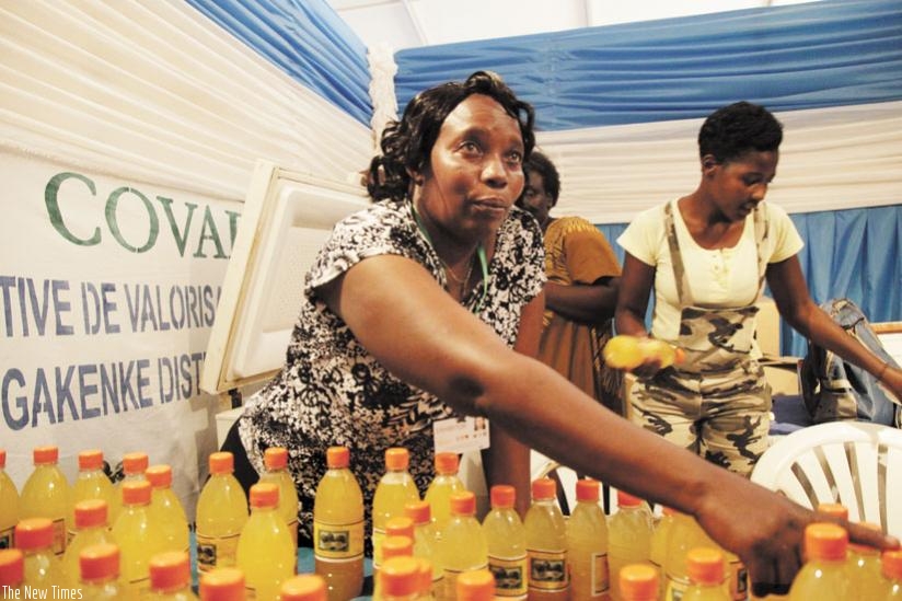 A Gakenke District juice producer talks to clients about her products at an exhibition in this 2013 photo. SMEs need to have solid HR strategies, too. (File)