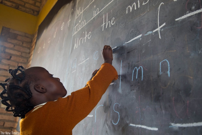 A pupil of Rusheshe Primary School in Kicukiro District engages in studies on the blackboard. (Timothy Kisambira)
