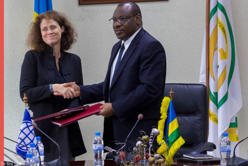 Carolyn Turk, the outgoing World Bank country manager (L) exchange documents with Finance Minister Gatete after the signing ceremony in Kigali yesterday. (All photos by Timothy Kisambira)